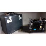 A 1951 Singer Featherweight portable sewing machine, model number 221K Centennial, in travel case