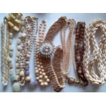 A quantity of mid to late 20th Century fashion jewellery to include shell necklaces, a soapstone