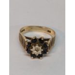 A 9ct gold daisy ring inset with a diamond and eight blue sapphires, total weight 3.0g Location: