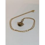 A 9ct gold necklace with a 9ct gold spinning four stone fob pendant, total weight 5.5g Location: