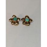 A pair of 9ct gold earrings in the form of a flower inset with opal, total weight 3.7g Location: