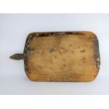 A late 19th century French pine breadboard of rectangular form, with a shaped handle, 79cm x 45cm