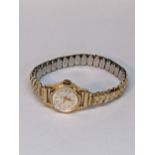 A ladies 18ct gold backed manual wind watch on an expanding bracelet Location: