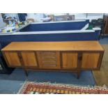 A G-plan teak sideboard designed by Viktor Wilkins having central drawers flanked by four field