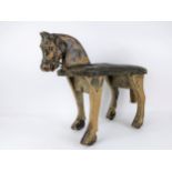 A 19th century part painted pine child's stool modelled as a horse, with a cared head, glass eyes,