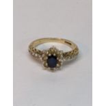 A 9ct gold cluster ting inset with central blue sapphire surrounded by diamonds, 2.9g Location: