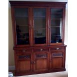 A Victorian Maple & Co mahogany bookcase having three glazed doors, loose shelves, three drawers and