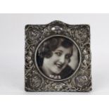 A late 19th century Continental silver photograph frame embossed and pierced with flowers, foliage