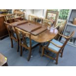 A 20th century Regency style mahogany twin pedestal dining table with a leaf and a rear set of six