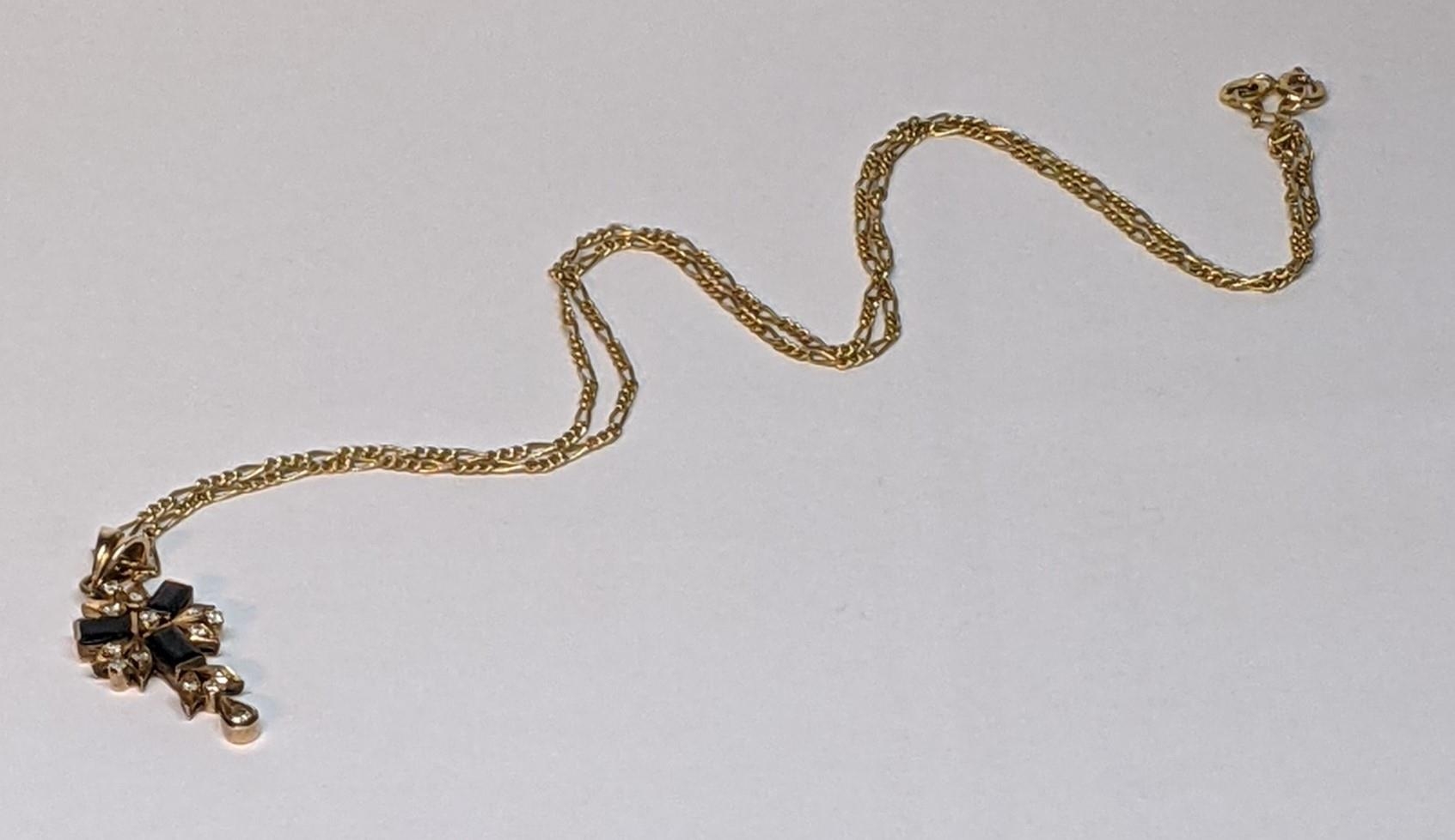 A 9ct gold necklace inset with 14 diamonds and three sapphires, total weight 4.9g Location: