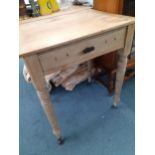 A Victorian pine side table with a drawer, on turned legs and castors, 75cm h x 62cm w x 50cm w