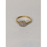 An 18ct yellow gold and platinum diamond set ring, the octagonal plaque top in daisy style set