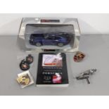 Porsche related items to include car badges, keyrings, 1:18 model and book together with a Jaguar