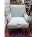 A limed wood armchair with scrolled end arms, fluted decoration on square tapering legs with