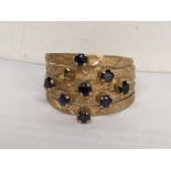 An 18ct gold ring having eight sapphires (one missing) stamped 18k, 3.6g Location: