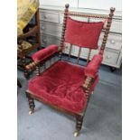 A 19th century rosewood bobbin turned armchair raised on turned front legs terminating on castors