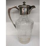 An Edwardian cut glass claret jug having a silver top and handle, hallmarked Sheffield 1910