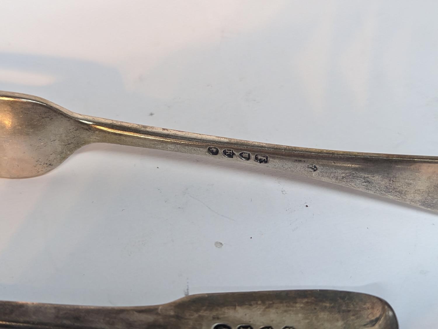A group of silver flatware to include a Georgian 1806 spoon A/F, 1830 fork and one other 1885 - Image 4 of 5