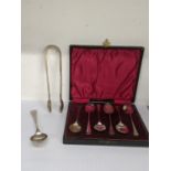 A boxed set of silver teaspoons, hallmarked Birmingham 1922, together with a pair of sugar tongs,