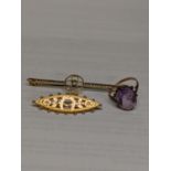 Two 9ct gold brooches, one with a steel pin, a 9ct gold and silver ring with purple stone, total