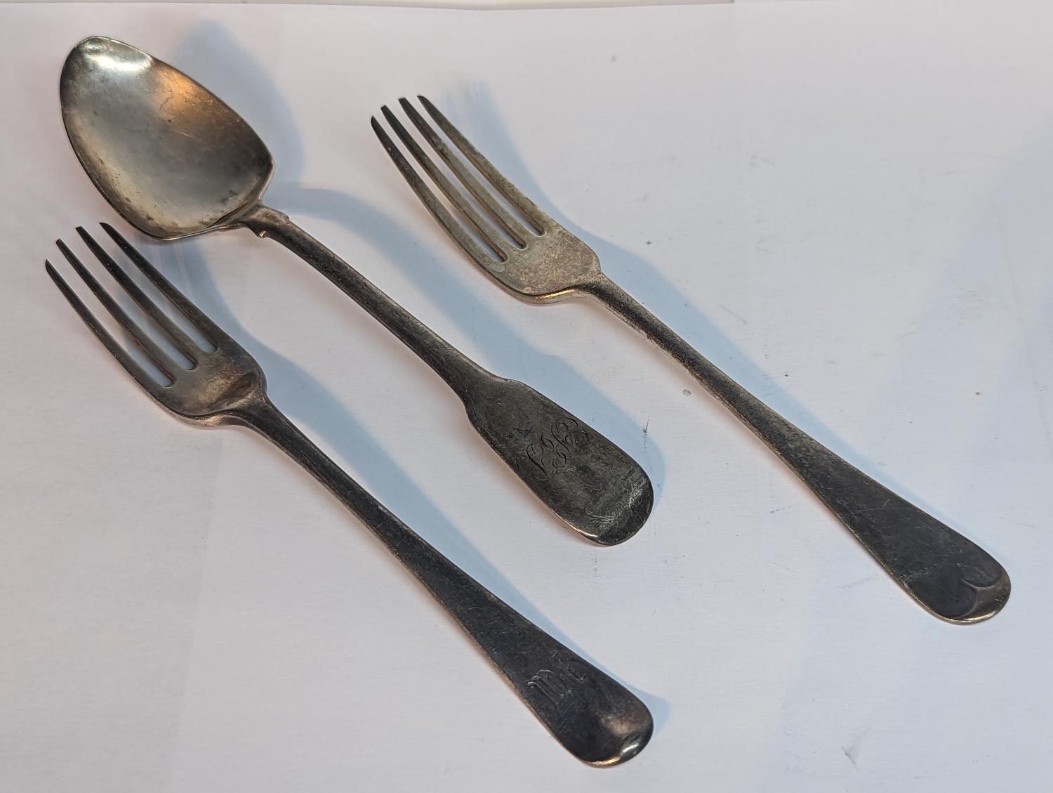 A group of silver flatware to include a Georgian 1806 spoon A/F, 1830 fork and one other 1885