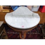 A Victorian Duchess wash stand with extended marble top, carved front leg support on shaped base
