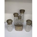 Victorian silver and glass dressing table items to include four embossed jars and a matching hip