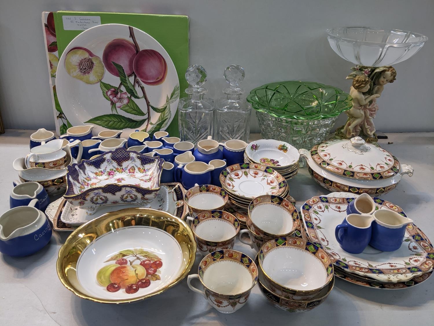 A mixed lot to include a collection of Devon ware jugs, Thomas Webb decanters, a large Portmerion