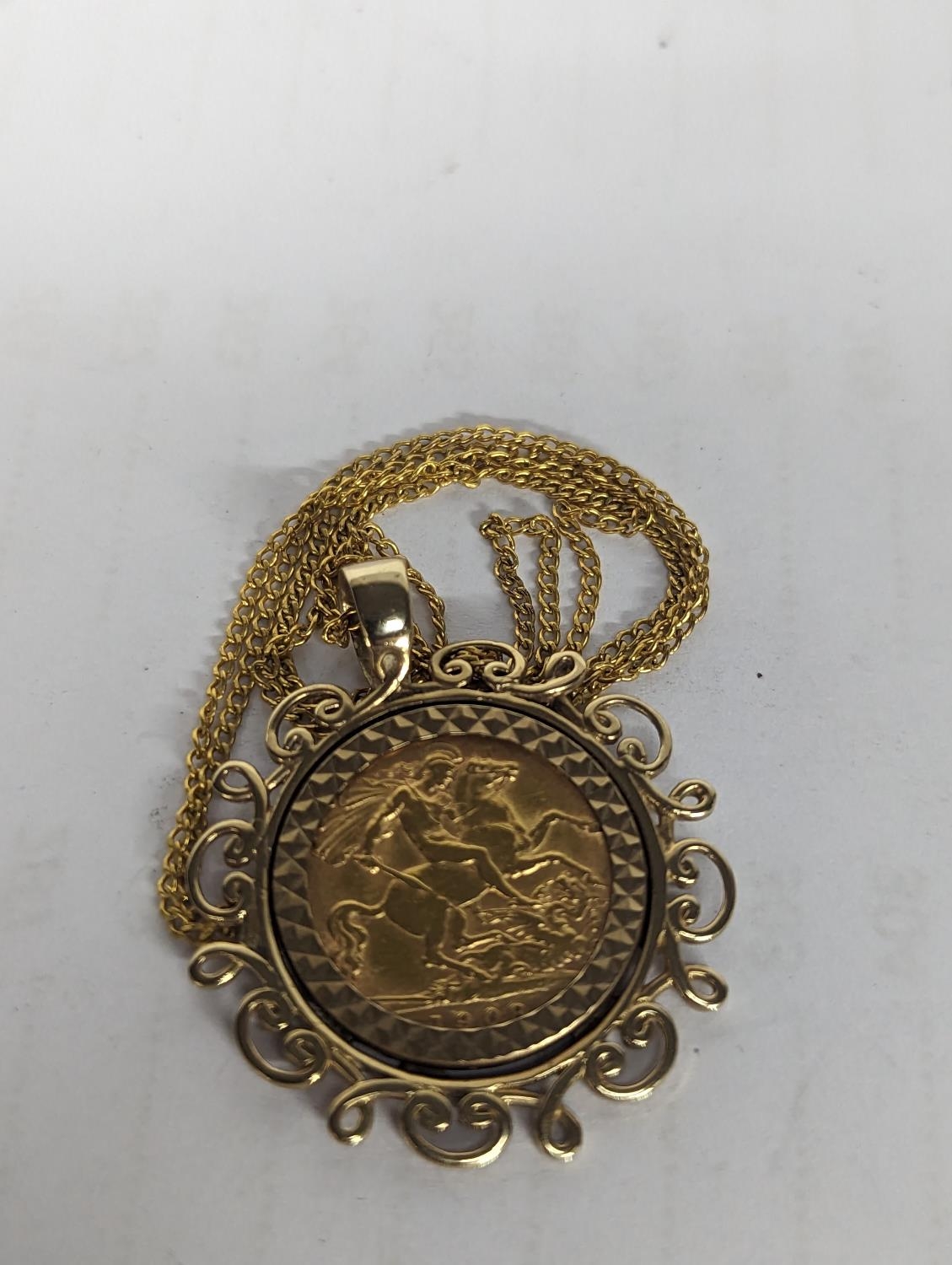 A 1908 Edward VII half sovereign, in a 9ct gold pendant setting, with later chain, 8.4g Location: