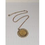 A George V 1914 half sovereign, mounted on a yellow metal pendant, on a 9ct gold chain, total weight