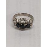 A 14ct white gold ring inset with diamonds and three blue sapphires, total weight 5.0g Location: