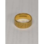 A 22ct gold wedding band with engraving detail, total weight 9.3g Location: