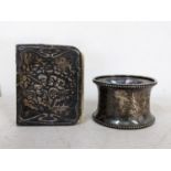 A silver napkin ring and a prayer book decorated with cherubs Location: