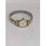 A ladies Omega manual wind 9ct gold wristwatch and a later expanding bracelet Location:
