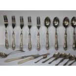 Silver handled forks and spoons stamped "800" together with silver tea spoons, and a sugar sifter