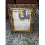 A gilt framed and ebonized wall mirror with rectangular bevelled glass 73cm x 61cm, and a silver