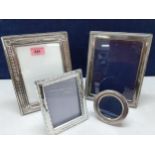 Three silver photo frames, 23cm x 18cm (2) and 19cm dia, together with another 15cm x 12cm Location: