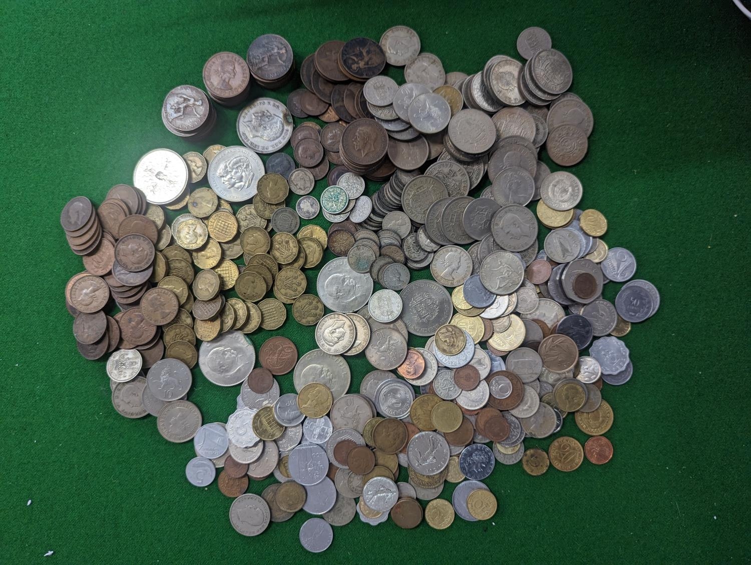 A mixed quantity of British and World coinage to include Victorian and later pennies and three pence