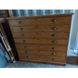 A late 19th/early 20th century pine architects plan/map chest having seven drawers with brass cup