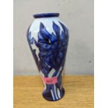 A contemporary Moorcroft vase decorated with blue irises on an inverted baluster shape, circa