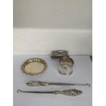 Two silver handled button hooks marked Birmingham 1903, together with a napkin ring and coaster,