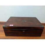 A Victorian mahogany travelling writing box with inset brass handles and corners, partially fitted