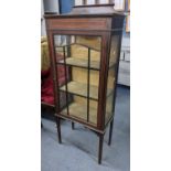 An Edwardian mahogany string inlaid display cabinet having single glazed door and on tapering legs