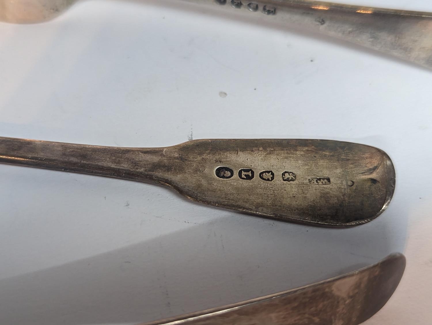 A group of silver flatware to include a Georgian 1806 spoon A/F, 1830 fork and one other 1885 - Image 3 of 5