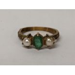 A 9ct gold emerald ring flanked by two cultured pearls, 2.6g Location:
