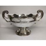 An early 20th century silver twin handled bowl having scroll shaped handles, scalloped rim and a