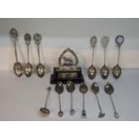 A collection of white metal spoons, some with initials to the terminals, together with a silver