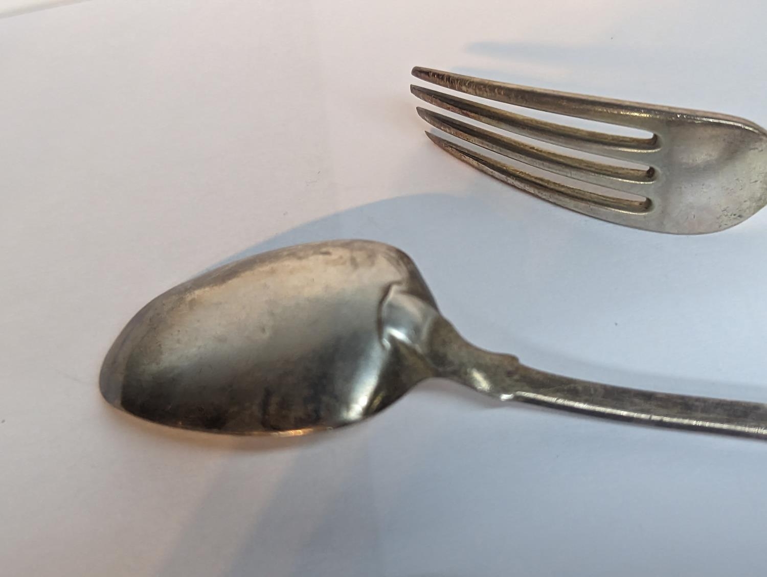 A group of silver flatware to include a Georgian 1806 spoon A/F, 1830 fork and one other 1885 - Image 2 of 5