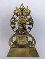 A Victorian brass skeleton clock having a pierced chapter ring with Roman numerals, the movement