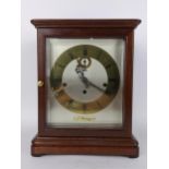 A mid/late 20th century Kieninger mahogany mantle clock, the silvered dial having brass chapter ring